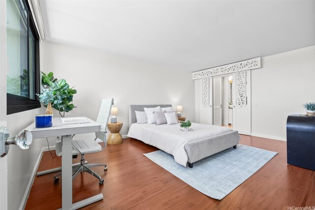 250 Kawaihae St Unit 18D, Honolulu, HI 96825 - bedroom featuring wood finished floors and a desk