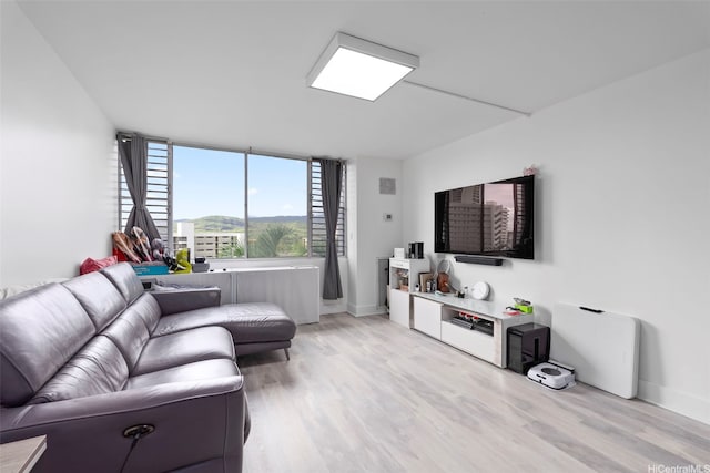 3045 Ala Napuaa Pl Unit 311, Honolulu, HI 96818 - living room featuring light wood-style flooring and baseboards