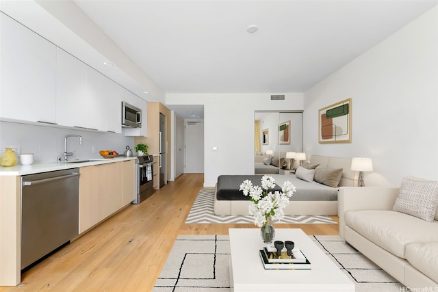 1001 Queen St Unit 1010, Honolulu, HI 96814 - living room featuring light wood-style flooring