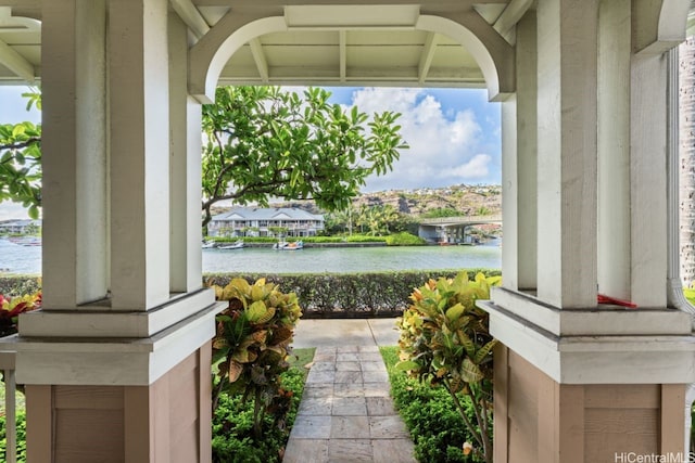 view of patio / terrace with a water view and a porch