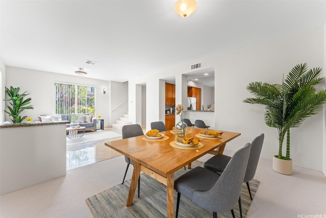 dining room with visible vents and stairs
