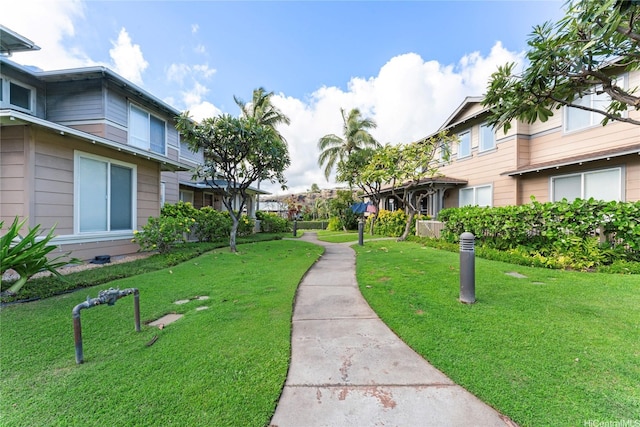 view of property's community featuring a yard