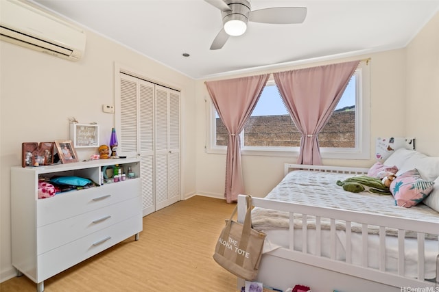 760 Onaha St, Honolulu, HI 96816 - bedroom featuring a wall mounted AC, light wood-type flooring, a closet, baseboards, and ceiling fan
