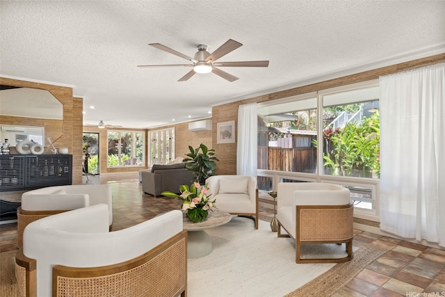 760 Onaha St, Honolulu, HI 96816 - living room with a ceiling fan, plenty of natural light, a textured ceiling, a wall mounted air conditioner, and stone finish flooring