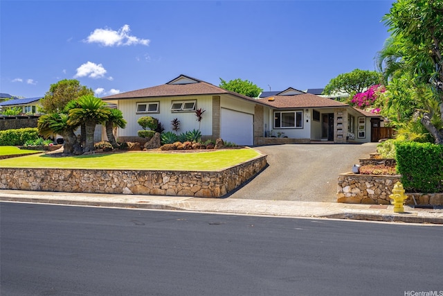 760 Onaha St, Honolulu, HI 96816 - ranch-style house with an attached garage, a front yard, solar panels, and asphalt driveway