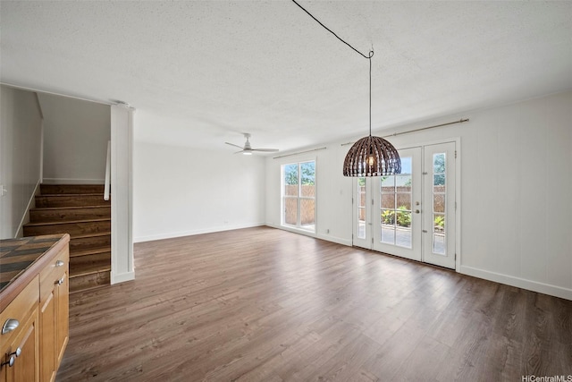 92-783 Makakilo Dr Unit C19, Kapolei, HI 96707 - unfurnished dining area featuring wood finished floors, stairway, baseboards, a textured ceiling, and ceiling fan