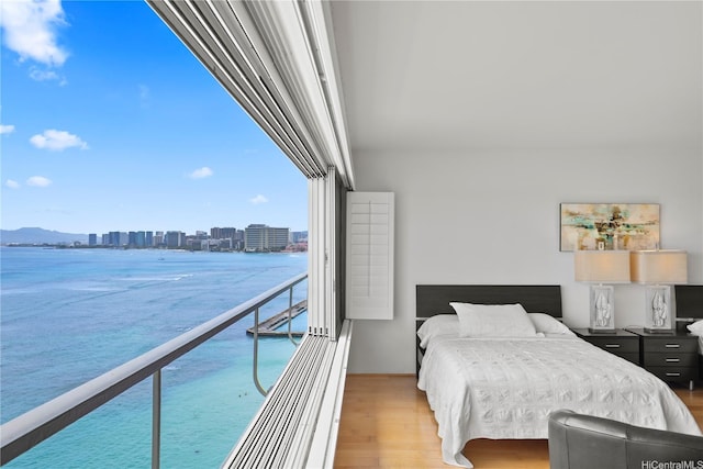 2895 Kalakaua Ave Unit 1202, Honolulu, HI 96815 - bedroom featuring light wood-style floors and a water view