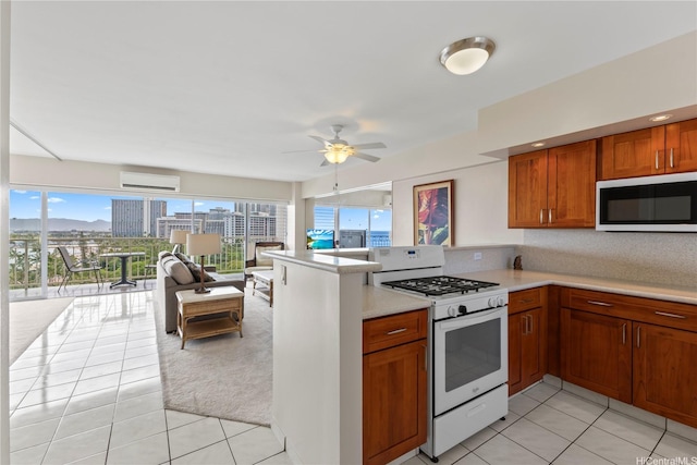 2161 Kalia Rd Unit 1112, Honolulu, HI 96815 - kitchen featuring white gas range, open floor plan, a wall mounted air conditioner, and light tile patterned floors