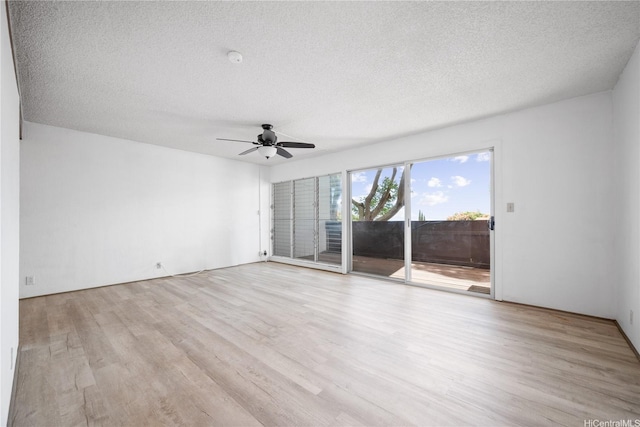 spare room featuring a textured ceiling, ceiling fan, and light wood-style flooring