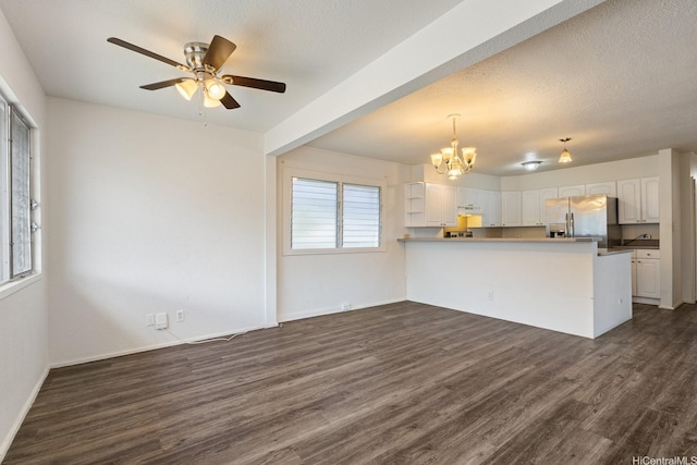 1180 Wanaka St, Honolulu, HI 96818 - kitchen with stainless steel refrigerator with ice dispenser, a chandelier, dark wood-style floors, a peninsula, and white cabinets