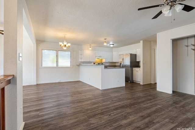 1180 Wanaka St, Honolulu, HI 96818 - kitchen featuring stainless steel fridge, a peninsula, a textured ceiling, white cabinets, and dark wood finished floors