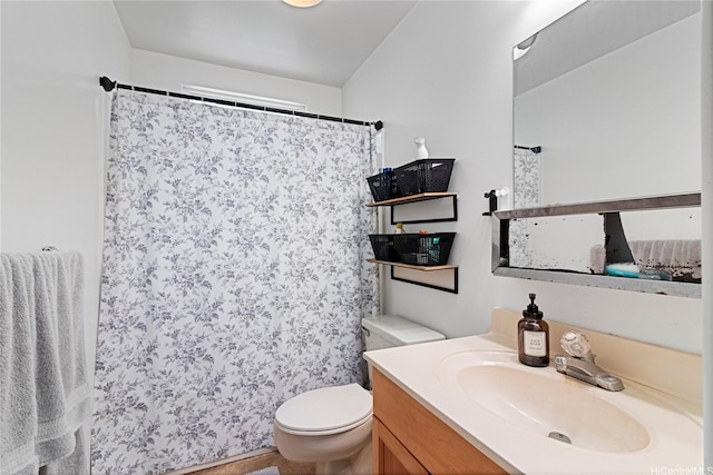 bathroom with vanity, curtained shower, and toilet