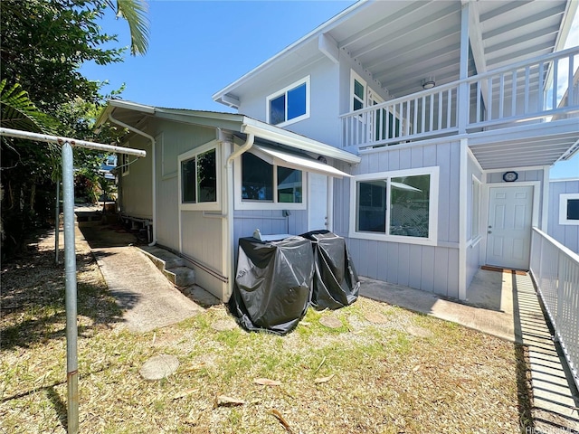 view of side of home with a balcony