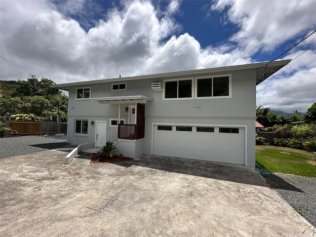44-665 Kaneohe Bay Dr, Kaneohe, HI 96744 - split foyer home with concrete driveway, fence, an attached garage, and an AC wall unit