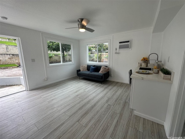 44-665 Kaneohe Bay Dr, Kaneohe, HI 96744 - living area with an AC wall unit, a ceiling fan, light wood-style floors, and baseboards