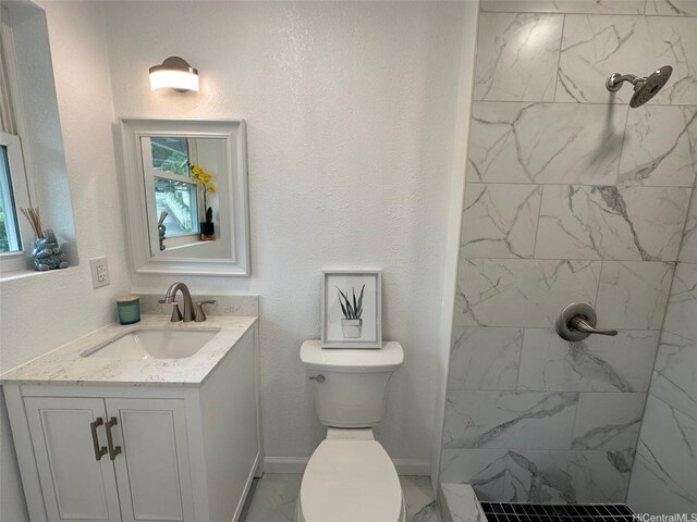 44-665 Kaneohe Bay Dr, Kaneohe, HI 96744 - full bath with a tile shower, toilet, marble look tile flooring, vanity, and baseboards