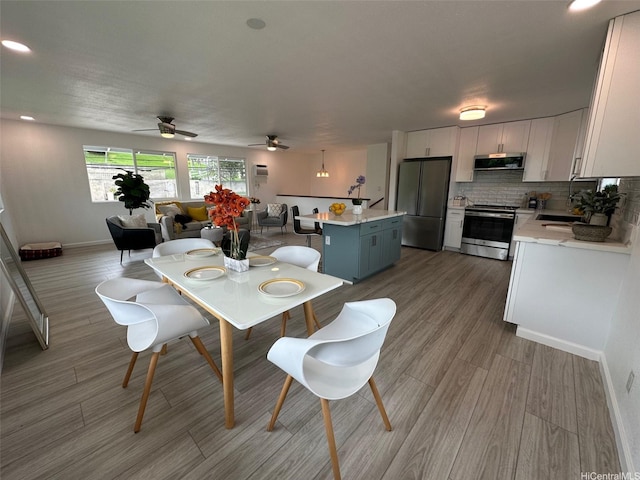 44-665 Kaneohe Bay Dr, Kaneohe, HI 96744 - dining area featuring baseboards, light wood finished floors, ceiling fan, and recessed lighting