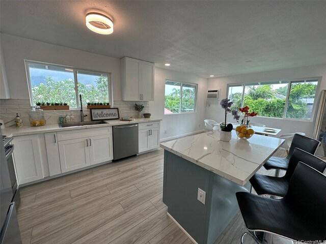 44-665 Kaneohe Bay Dr, Kaneohe, HI 96744 - kitchen with a sink, stainless steel dishwasher, white cabinetry, decorative backsplash, and recessed lighting