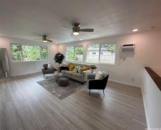 44-665 Kaneohe Bay Dr, Kaneohe, HI 96744 - living room featuring baseboards, wood finished floors, a ceiling fan, a wall unit AC, and recessed lighting