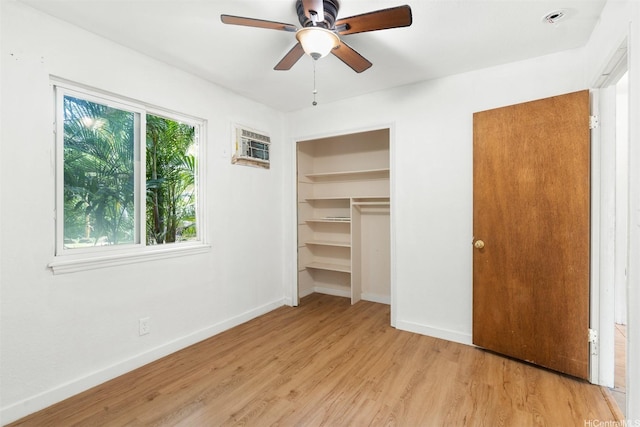 unfurnished bedroom featuring light wood-style flooring, baseboards, and ceiling fan