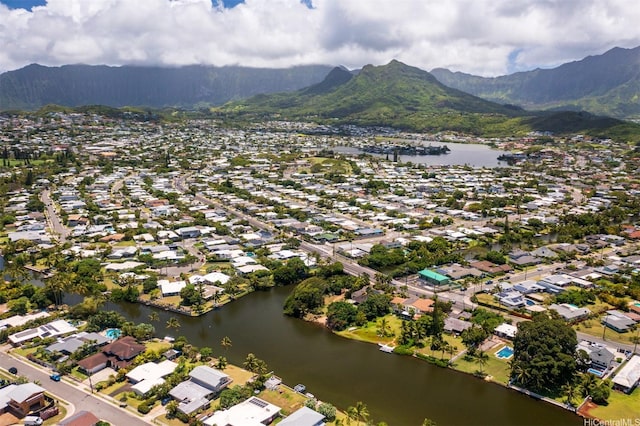 drone / aerial view featuring a residential view and a water and mountain view
