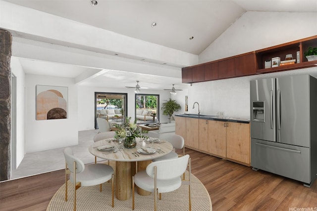 dining area featuring vaulted ceiling, ceiling fan, and wood finished floors