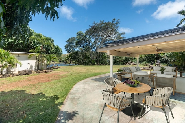 view of patio featuring a water view and an outdoor living space