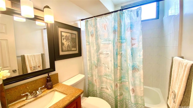 bathroom with vanity, toilet, and shower / tub combo with curtain