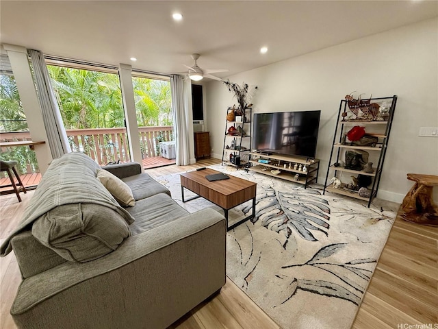 living room featuring wood finished floors, baseboards, a ceiling fan, and recessed lighting