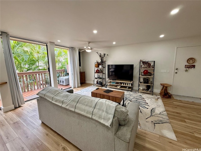 living room with recessed lighting, floor to ceiling windows, baseboards, ceiling fan, and light wood-type flooring