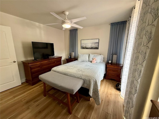 bedroom with ceiling fan and wood finished floors