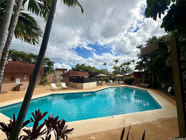 community pool with a patio area
