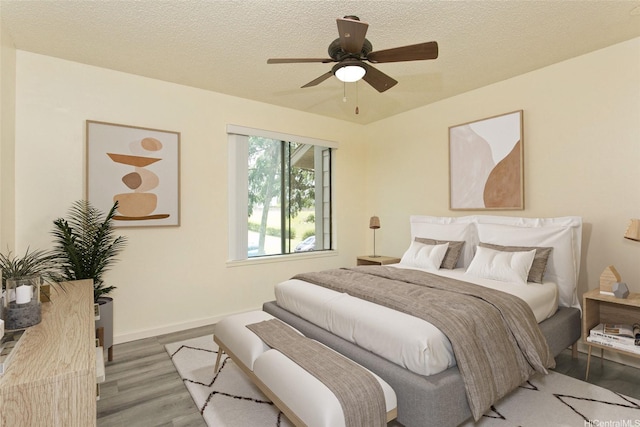 98-1819 Kaahumanu St Unit 78B, Aiea, HI 96701 - bedroom featuring wood finished floors, baseboards, a textured ceiling, and a ceiling fan