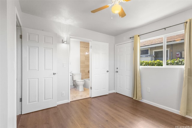 84-541 Nukea St, Waianae, HI 96792 - unfurnished bedroom featuring baseboards, ensuite bath, ceiling fan, and wood finished floors