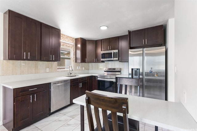 84-541 Nukea St, Waianae, HI 96792 - kitchen featuring a sink, marble finish floor, dark brown cabinetry, backsplash, and appliances with stainless steel finishes