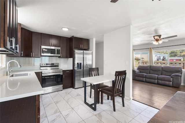 84-541 Nukea St, Waianae, HI 96792 - kitchen with a ceiling fan, marble finish floor, a sink, light countertops, and appliances with stainless steel finishes