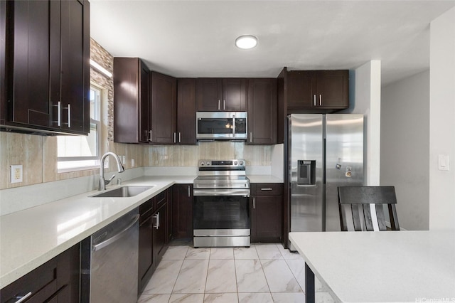 84-541 Nukea St, Waianae, HI 96792 - kitchen with dark brown cabinets, a sink, stainless steel appliances, light countertops, and marble finish floor
