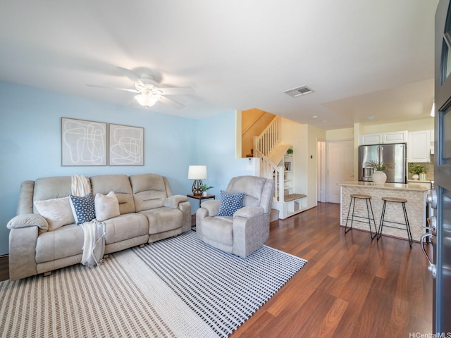 91-2067 Kaioli St Unit 503, Ewa Beach, HI 96706 - living area featuring dark wood-type flooring, stairway, and ceiling fan