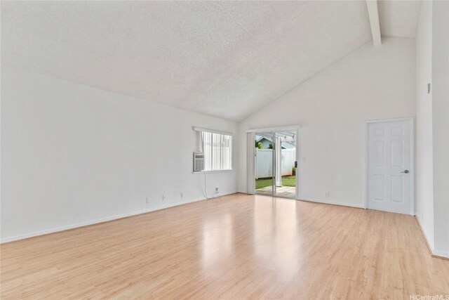 unfurnished room with high vaulted ceiling, light wood-type flooring, beam ceiling, baseboards, and a textured ceiling
