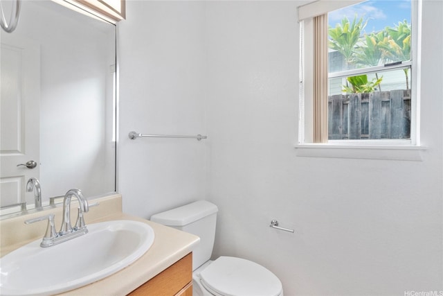 half bathroom with toilet and vanity