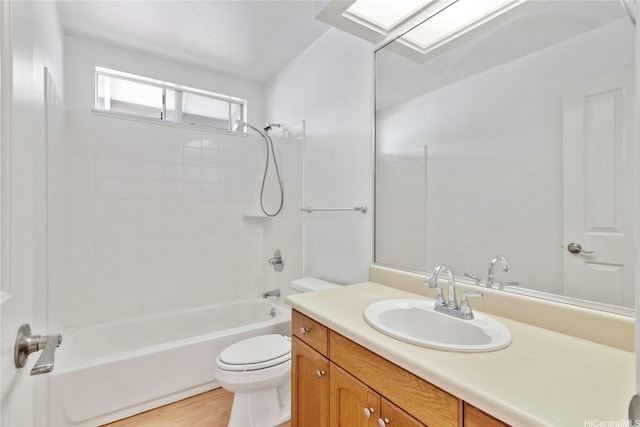 bathroom featuring toilet, shower / washtub combination, vanity, and wood finished floors