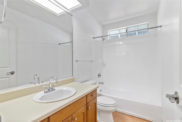 bathroom with toilet, vanity, shower / bathtub combination, and wood finished floors