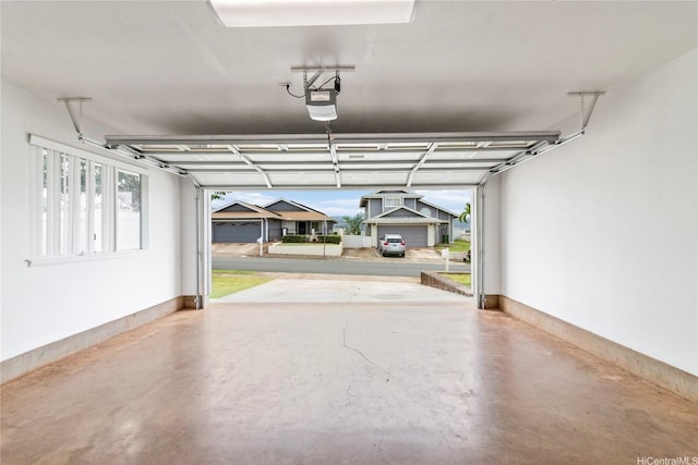 garage with a garage door opener and baseboards