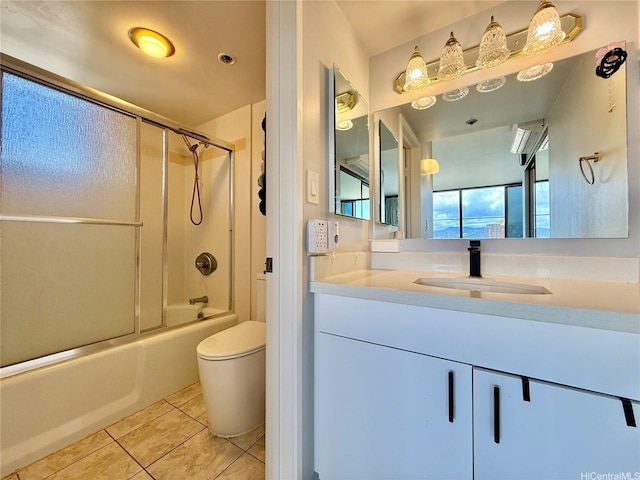 990 Ala Nanala St Unit 19A, Honolulu, HI 96818 - full bathroom with tile patterned floors, vanity, toilet, and combined bath / shower with glass door