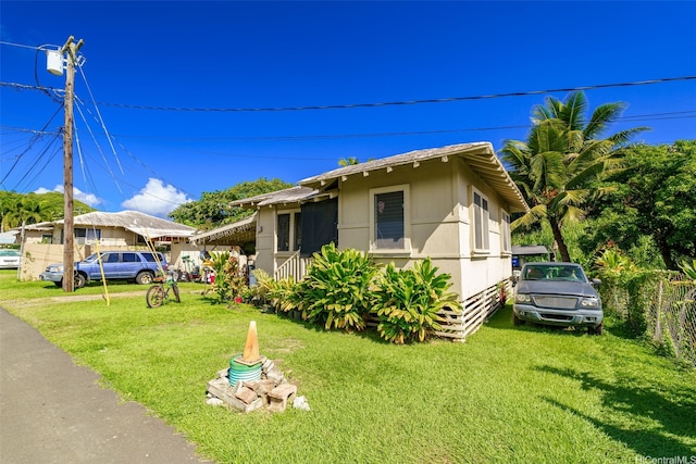 view of front of property with fence and a front lawn