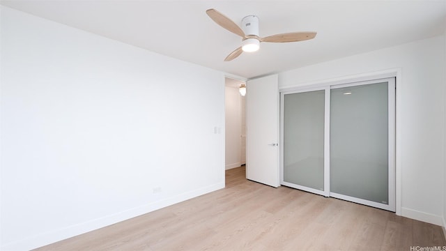 unfurnished bedroom with light wood finished floors, baseboards, and ceiling fan