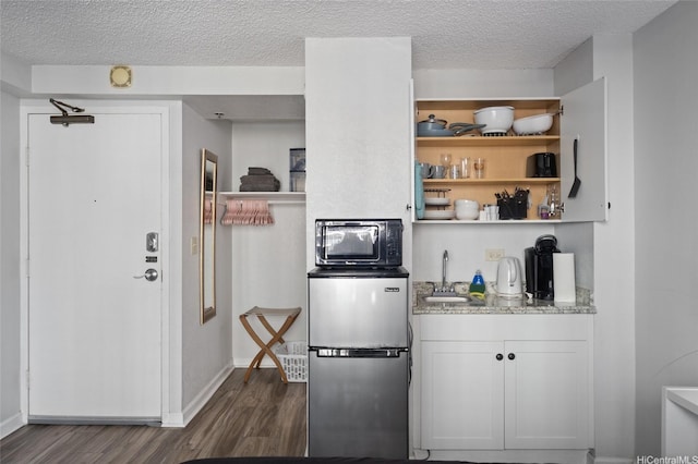 1920 Ala Moana Blvd Unit 602, Honolulu, HI 96815 - interior space with open shelves, light stone counters, dark wood-style floors, and a sink