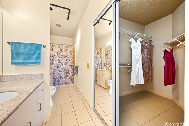 91-1012 Laaulu St Unit 28A, Ewa Beach, HI 96706 - full bath featuring vanity, tile patterned flooring, a shower with curtain, and a spacious closet