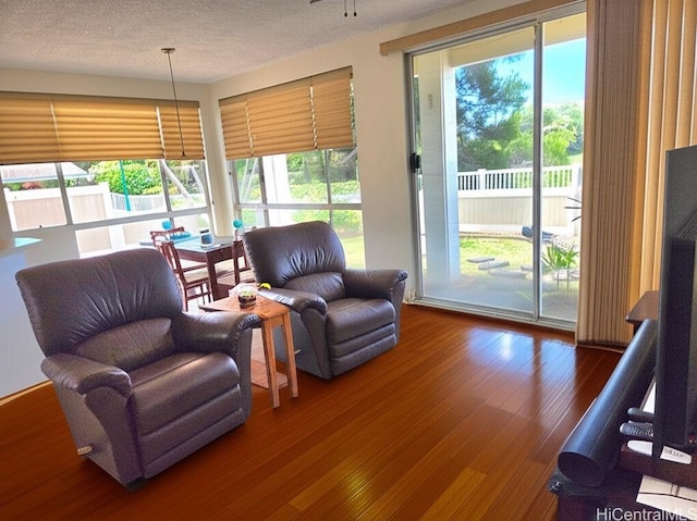 91-1012 Laaulu St Unit 28A, Ewa Beach, HI 96706 - living room with wood finished floors and a textured ceiling