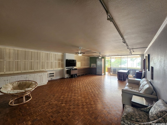 2500 Kalakaua Ave Unit 201, Honolulu, HI 96815 - living area with rail lighting, a ceiling fan, a textured ceiling, and an AC wall unit